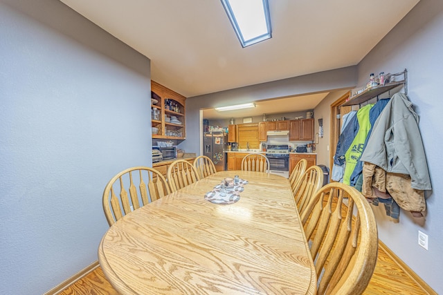 26015 County Road 262, Hermitage, MO 65668 - dining space featuring baseboards and light wood finished floors