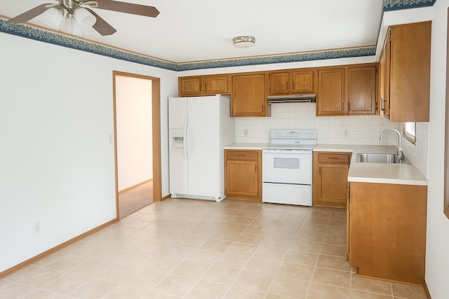 114 S Pinewood Ave, Republic, MO 65738 - kitchen featuring white appliances, under cabinet range hood, brown cabinets, a ceiling fan, and light countertops