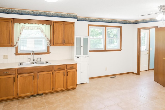 114 S Pinewood Ave, Republic, MO 65738 - kitchen with brown cabinets, plenty of natural light, and a ceiling fan