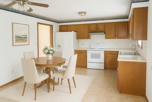 114 S Pinewood Ave, Republic, MO 65738 - kitchen with white appliances, under cabinet range hood, brown cabinets, light countertops, and a ceiling fan
