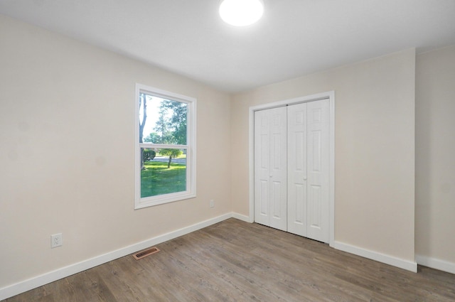 2131 N Pickwick Ave, Springfield, MO 65803 - unfurnished bedroom with wood finished floors and a closet
