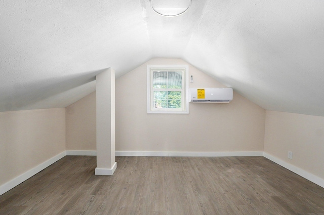 2131 N Pickwick Ave, Springfield, MO 65803 - bonus room featuring a wall mounted air conditioner, a textured ceiling, wood finished floors, and lofted ceiling