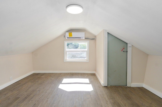 2131 N Pickwick Ave, Springfield, MO 65803 - additional living space with a wall unit AC, wood finished floors, and vaulted ceiling