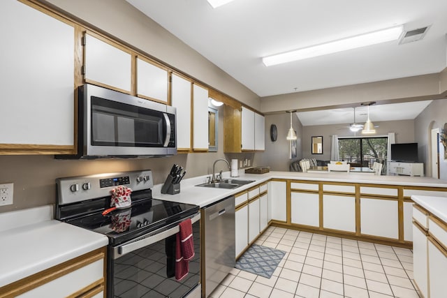 350 Wildwood Dr S Unit 31, Branson, MO 65616 - kitchen featuring stainless steel appliances, light countertops, light tile patterned floors, pendant lighting, and white cabinets