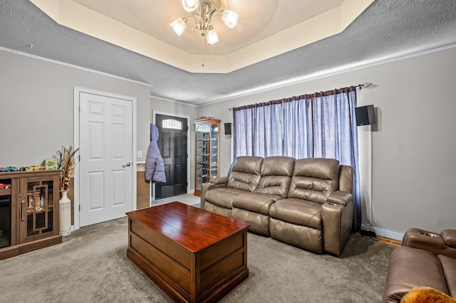 105 W Oak St, Nixa, MO 65714 - living room featuring carpet, ceiling fan, a textured ceiling, a raised ceiling, and ornamental molding