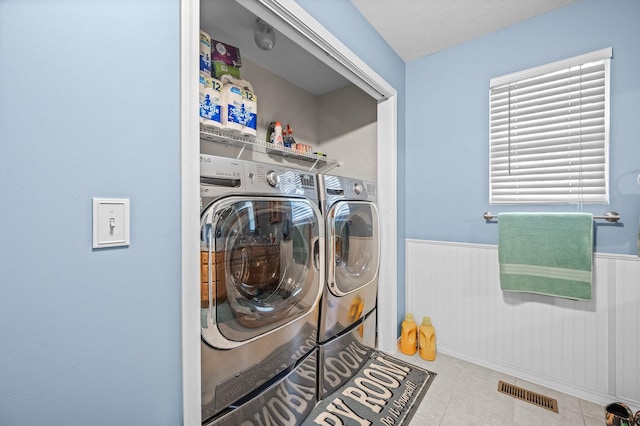 105 W Oak St, Nixa, MO 65714 - laundry area featuring separate washer and dryer, wainscoting, and tile patterned floors