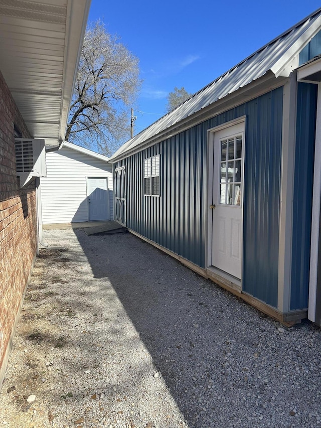 105 W Oak St, Nixa, MO 65714 - view of side of property featuring board and batten siding, a metal roof, and an outbuilding