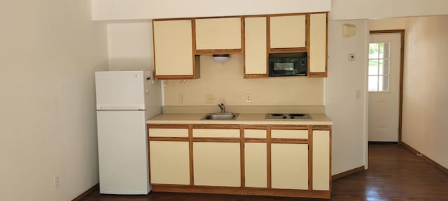 22 Fall Creek Trl Unit 5, Branson, MO 65616 - kitchen featuring freestanding refrigerator, black microwave, stainless steel cooktop, light countertops, and dark wood-style floors