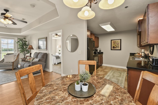 180 Grace Chapel Rd Unit 220, Blue Eye, MO 65611 - dining room with ceiling fan, a raised ceiling, and light wood-style floors
