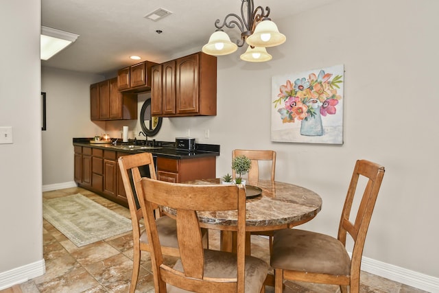 180 Grace Chapel Rd Unit 220, Blue Eye, MO 65611 - dining space with a chandelier and light stone finish flooring