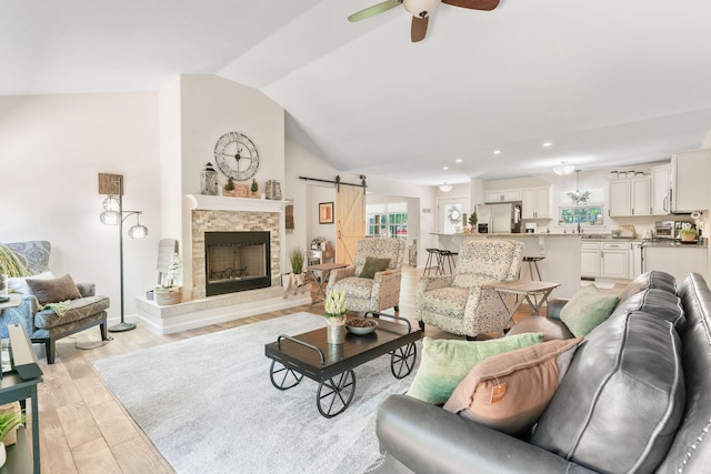 1865 Morningside Falls Blvd, Blue Eye, MO 65611 - living area with a barn door, a ceiling fan, lofted ceiling, healthy amount of natural light, and light wood-style floors