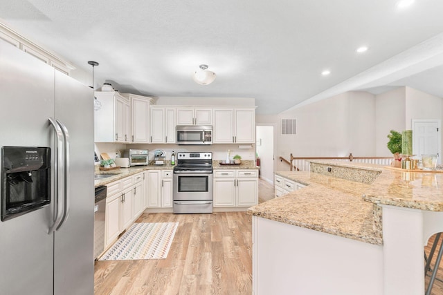 1865 Morningside Falls Blvd, Blue Eye, MO 65611 - kitchen with stainless steel appliances, light wood-style floors, white cabinetry, recessed lighting, and light stone counters