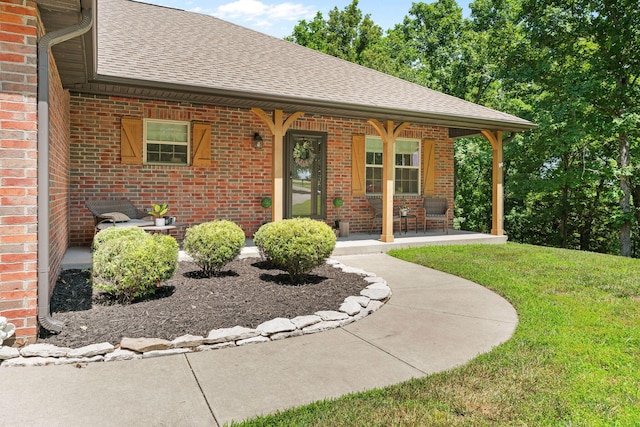 1865 Morningside Falls Blvd, Blue Eye, MO 65611 - view of front of house featuring a shingled roof, brick siding, covered porch, and a front yard