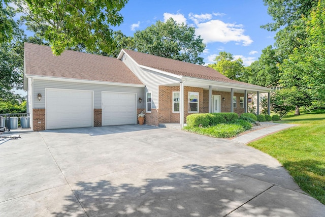 471 Table Rock Hts, Hollister, MO 65672 - view of front of property with brick siding, a garage, driveway, and a front lawn