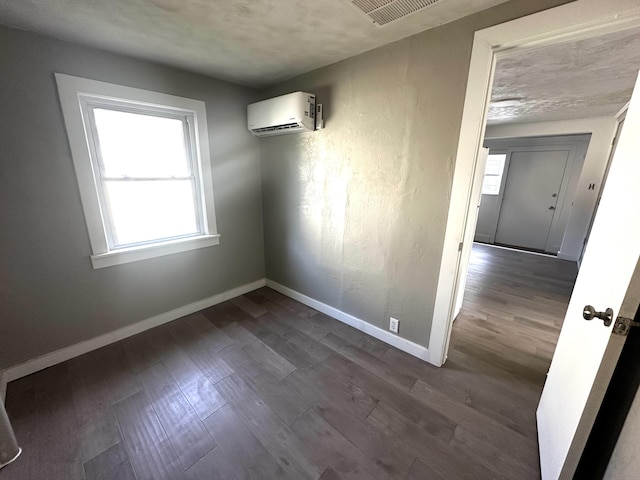2609 W Lombard St, Springfield, MO 65802 - unfurnished dining area with a wall unit AC and dark wood finished floors