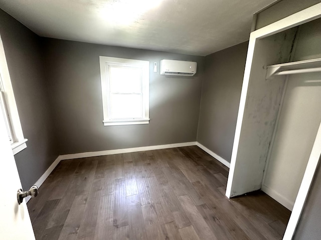 2609 W Lombard St, Springfield, MO 65802 - unfurnished bedroom with an AC wall unit and dark wood finished floors