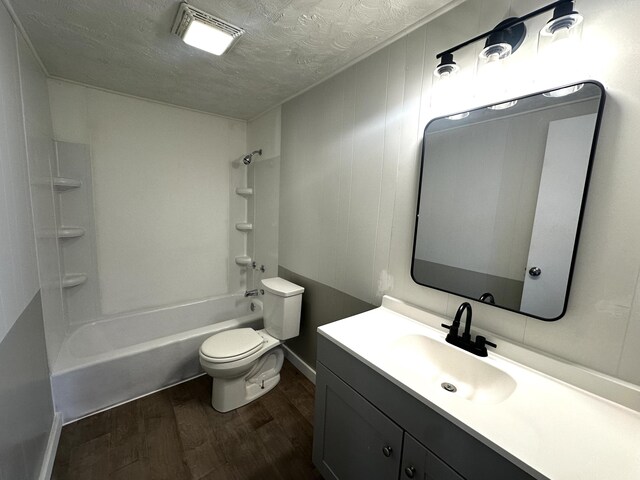 2609 W Lombard St, Springfield, MO 65802 - bathroom with wood finished floors, a textured ceiling, vanity, and bathing tub / shower combination