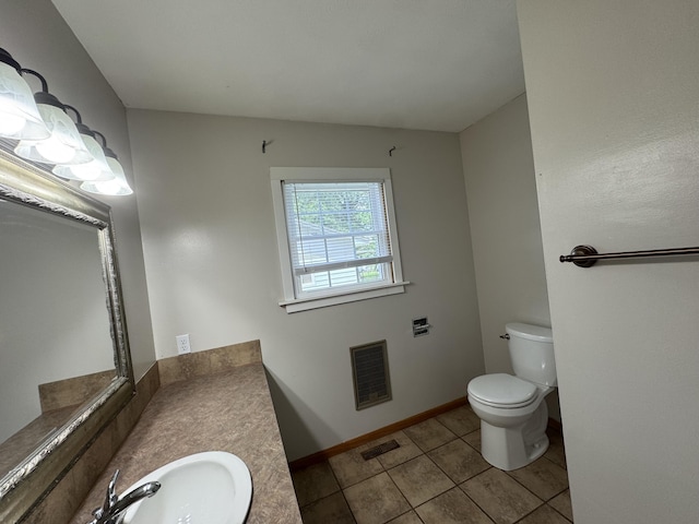 606 E Prairie Ln, Ash Grove, MO 65604 - half bath with heating unit, vanity, and tile patterned flooring