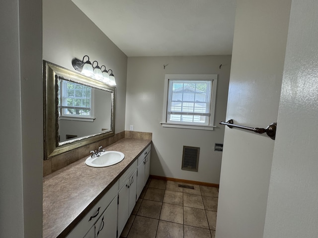 606 E Prairie Ln, Ash Grove, MO 65604 - bathroom featuring plenty of natural light, heating unit, vanity, and tile patterned floors