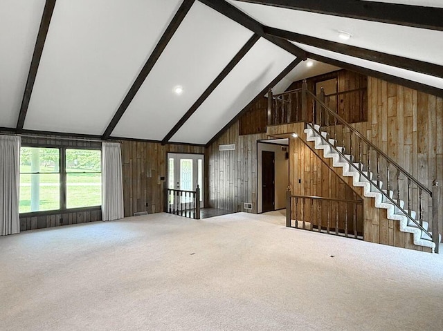 114 W Carman Rd, El Dorado Springs, MO 64744 - unfurnished living room featuring wooden walls, carpet flooring, and stairway