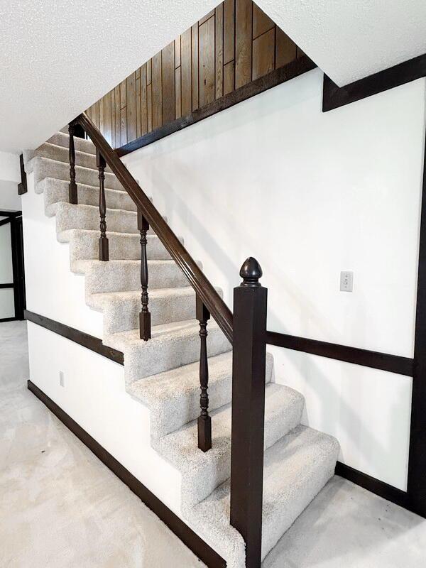 114 W Carman Rd, El Dorado Springs, MO 64744 - staircase with baseboards