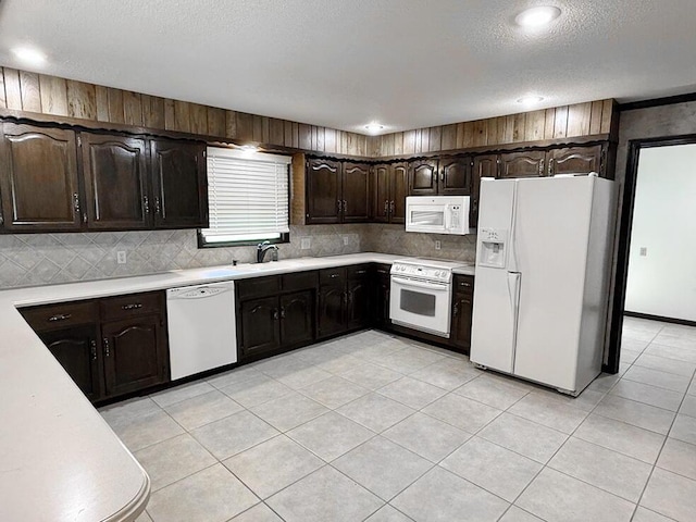114 W Carman Rd, El Dorado Springs, MO 64744 - kitchen featuring white appliances, light countertops, backsplash, dark brown cabinets, and a textured ceiling
