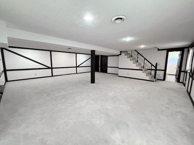 114 W Carman Rd, El Dorado Springs, MO 64744 - finished basement featuring a textured ceiling, stairs, and carpet