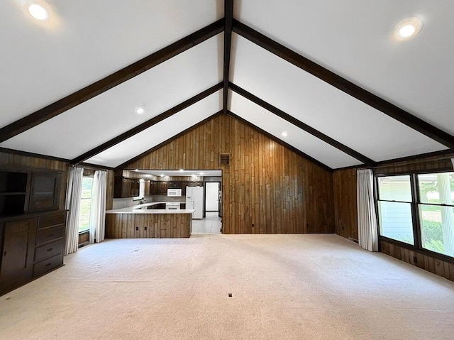 114 W Carman Rd, El Dorado Springs, MO 64744 - unfurnished living room with wooden walls, light colored carpet, and recessed lighting