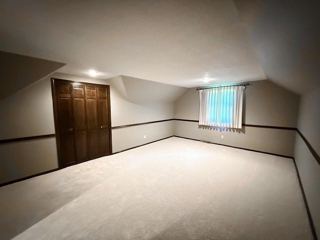 114 W Carman Rd, El Dorado Springs, MO 64744 - additional living space with vaulted ceiling and carpet