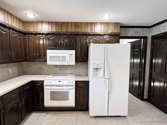 114 W Carman Rd, El Dorado Springs, MO 64744 - kitchen featuring white appliances, light countertops, dark brown cabinetry, light tile patterned floors, and a textured ceiling