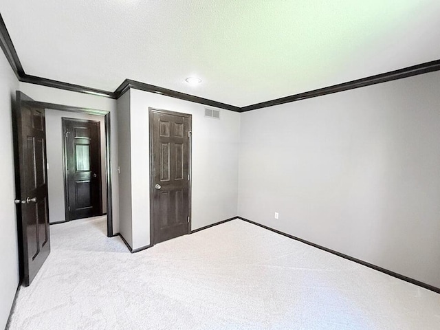 114 W Carman Rd, El Dorado Springs, MO 64744 - unfurnished bedroom featuring crown molding and light carpet