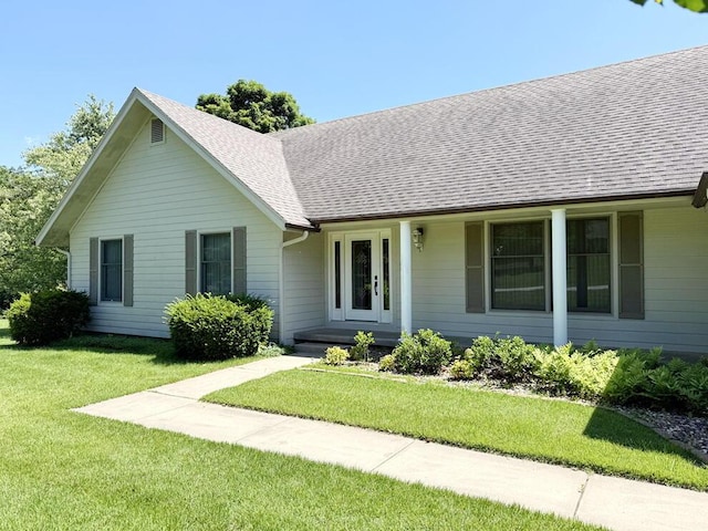 114 W Carman Rd, El Dorado Springs, MO 64744 - single story home with a front lawn and a shingled roof