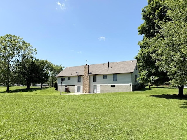 114 W Carman Rd, El Dorado Springs, MO 64744 - rear view of house featuring a yard