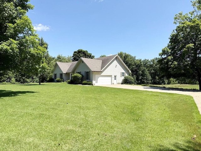 114 W Carman Rd, El Dorado Springs, MO 64744 - view of front of home with a front yard, concrete driveway, and an attached garage