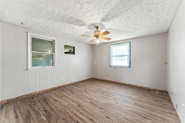 621 E Cleveland St, Seymour, MO 65746 - empty room featuring wood finished floors, a ceiling fan, and a textured ceiling