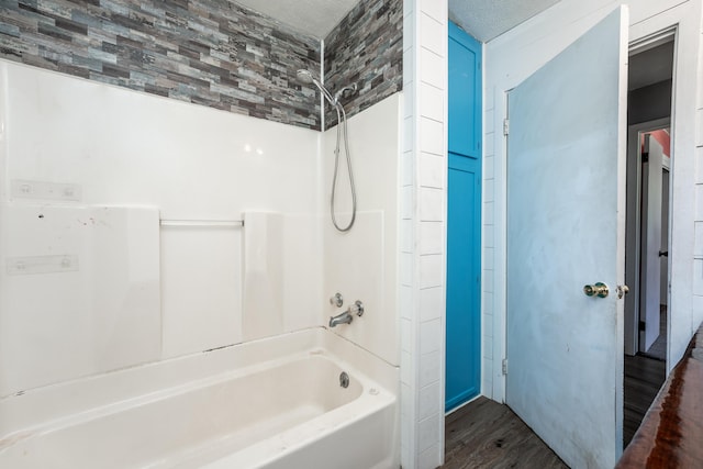 621 E Cleveland St, Seymour, MO 65746 - bathroom featuring wood finished floors and bathtub / shower combination