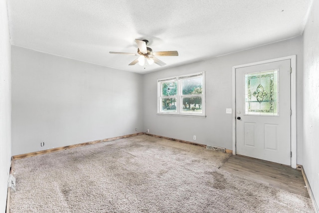 621 E Cleveland St, Seymour, MO 65746 - carpeted entrance foyer featuring a ceiling fan and a textured ceiling