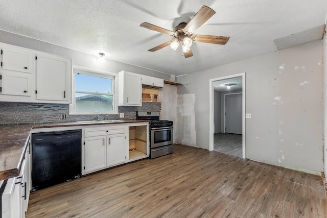 621 E Cleveland St, Seymour, MO 65746 - kitchen featuring dishwasher, stainless steel range with gas cooktop, light wood finished floors, tasteful backsplash, and white cabinetry