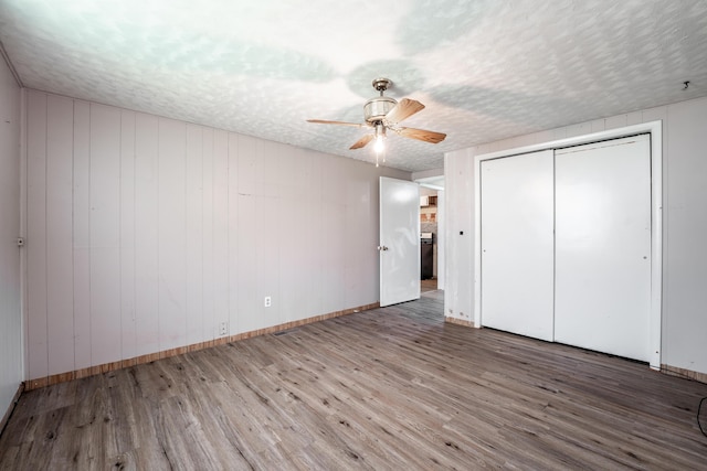 621 E Cleveland St, Seymour, MO 65746 - unfurnished bedroom featuring wood finished floors, a ceiling fan, a closet, and a textured ceiling