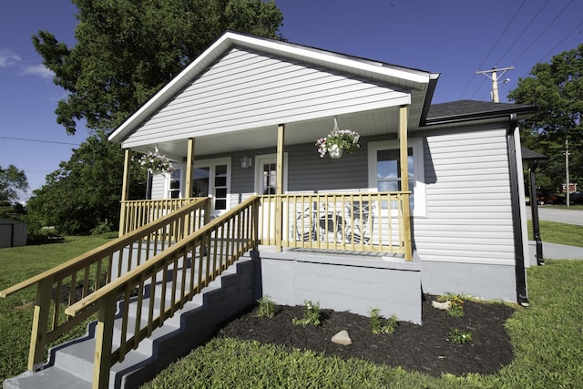 106 S 3rd Ave, Ozark, MO 65721 - view of front of home with a porch, a front lawn, a shingled roof, and crawl space