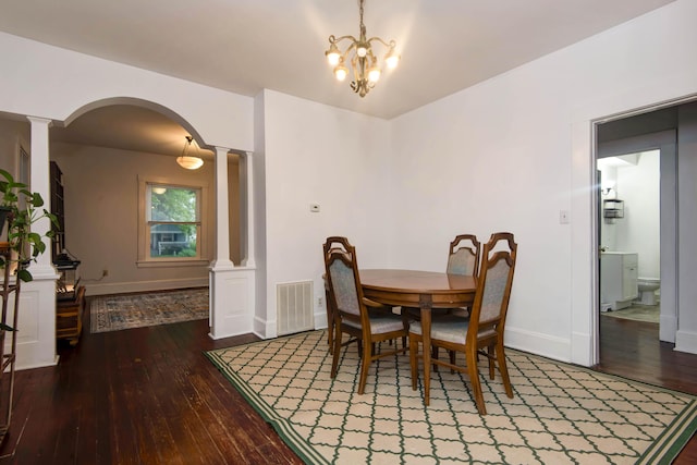 1510 E Mcdaniel St, Springfield, MO 65802 - dining space featuring ornate columns, hardwood / wood-style floors, arched walkways, and a chandelier