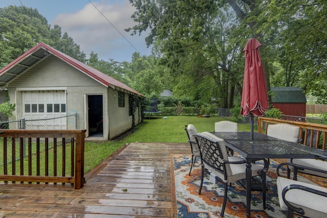 1510 E Mcdaniel St, Springfield, MO 65802 - wooden terrace with outdoor dining area, a storage unit, and a detached garage