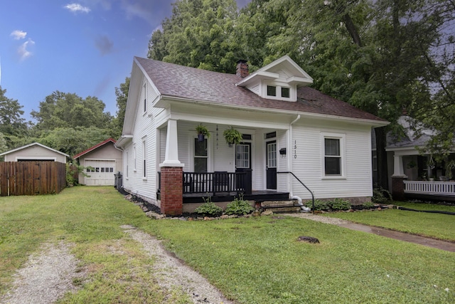1510 E Mcdaniel St, Springfield, MO 65802 - bungalow with a porch, a chimney, a detached garage, roof with shingles, and driveway