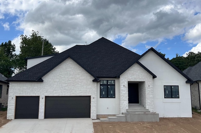3927 E Woodhue St, Springfield, MO 65802 - view of front of house with a shingled roof, stone siding, concrete driveway, and a garage