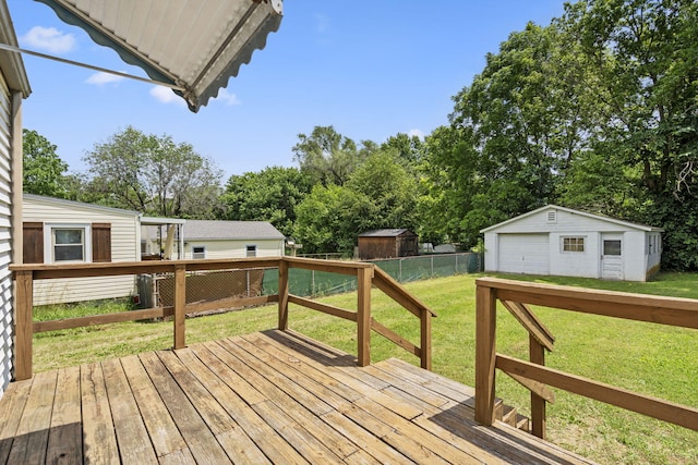 1524 S Thelma Ave, Springfield, MO 65807 - wooden deck with a garage, an outdoor structure, and view of wooded area