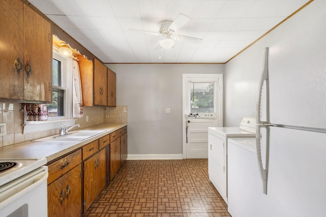 1524 S Thelma Ave, Springfield, MO 65807 - kitchen featuring freestanding refrigerator, independent washer and dryer, decorative backsplash, ceiling fan, and light countertops