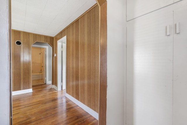 1524 S Thelma Ave, Springfield, MO 65807 - hallway with arched walkways, wooden walls, and wood finished floors
