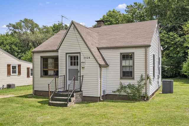 1524 S Thelma Ave, Springfield, MO 65807 - view of front of property with a shingled roof, a front lawn, and a chimney
