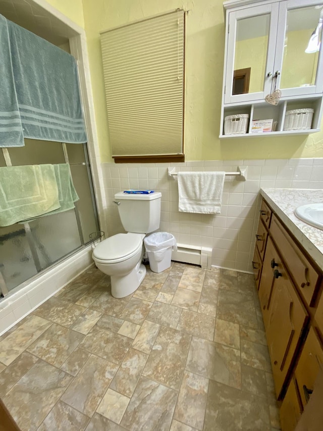 1605 S Park Ave, Aurora, MO 65605 - full bath with tile walls, vanity, a stall shower, stone finish floors, and a baseboard heating unit
