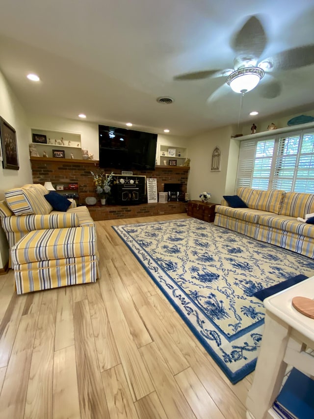 1605 S Park Ave, Aurora, MO 65605 - living area with a brick fireplace, a ceiling fan, wood finished floors, and recessed lighting